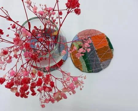 Upcycled textile coasters in clean minimalist composition. Fotos Stock