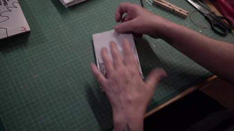 Upcycling a magazine sheet to paper bag ----- Stock Footage 167753353