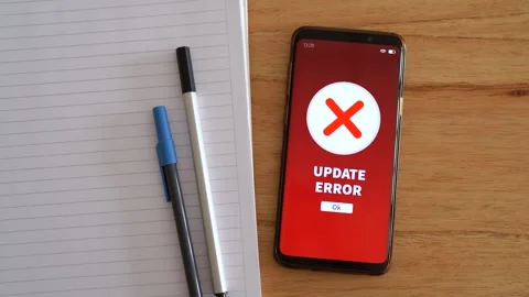 Update error notification on smartphone on desk. Concept of software update Stock Footage 297453213