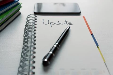 Update - handwritten text in a notebook on a desk. Project update checklist. Stock Photos