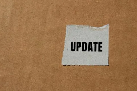 Update message written on ripped torn paper background. Conceptual Update s.. Stock Photos