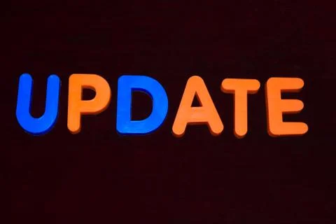 Update word written with different colored letter blocks on a dark background Stock Photos