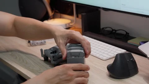 Updating DJI Mini 5 Pro firmware at studio workspace on September 5 2026 스톡 동영상 344617680
