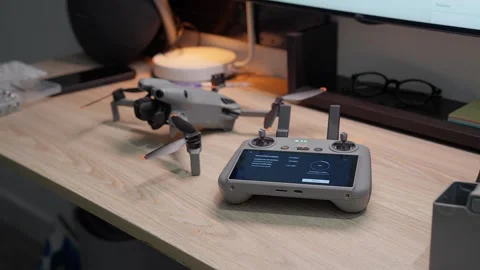 Updating DJI Mini 5 Pro firmware at studio workspace on September 5 2026 스톡 동영상 344619464