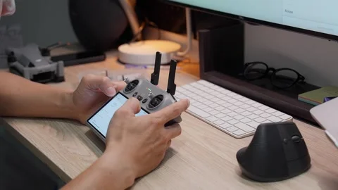Updating DJI Mini 5 Pro firmware at studio workspace on September 5 2026 스톡 동영상 344687631