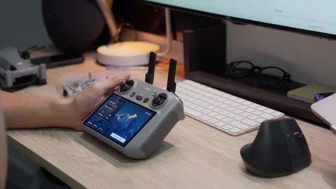 Updating DJI Mini 5 Pro firmware at studio workspace on September 5 2026 스톡 동영상 344687642