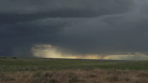 Updraft base with cloud to ground strokes dumping rain over prairie and Stock Footage 59525439