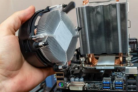 Upgrading installing more powerful cooler on a personal computer processor. T 写真素材