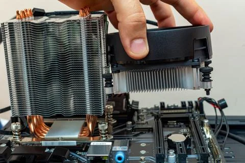 Upgrading installing more powerful cooler on a personal computer processor. T 写真素材