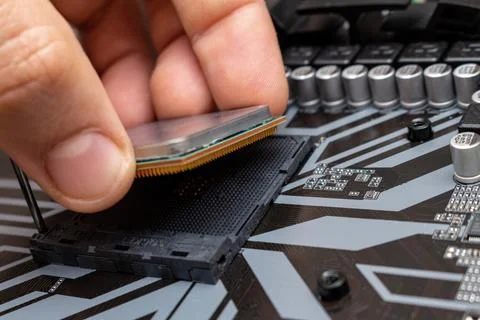 Upgrading installing more powerful CPU on a personal computer. The process co 스톡 사진