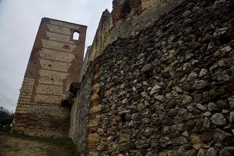 Uphill dirt path bordered by an olive tree grove and an ancient boundary wa.. Stock Photos
