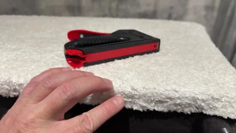 Upholsterer holding a mechanical stapler for upholstering furniture, insert.. Stock Footage 320226072