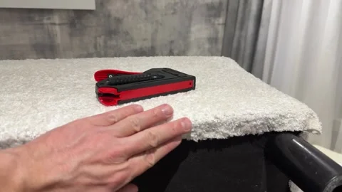 Upholsterer holding a mechanical stapler for upholstering furniture, insert.. Video stock 320226081