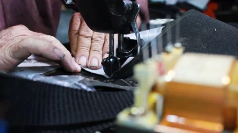 An upholsterer working on a sewing machine Stock Footage 304713847