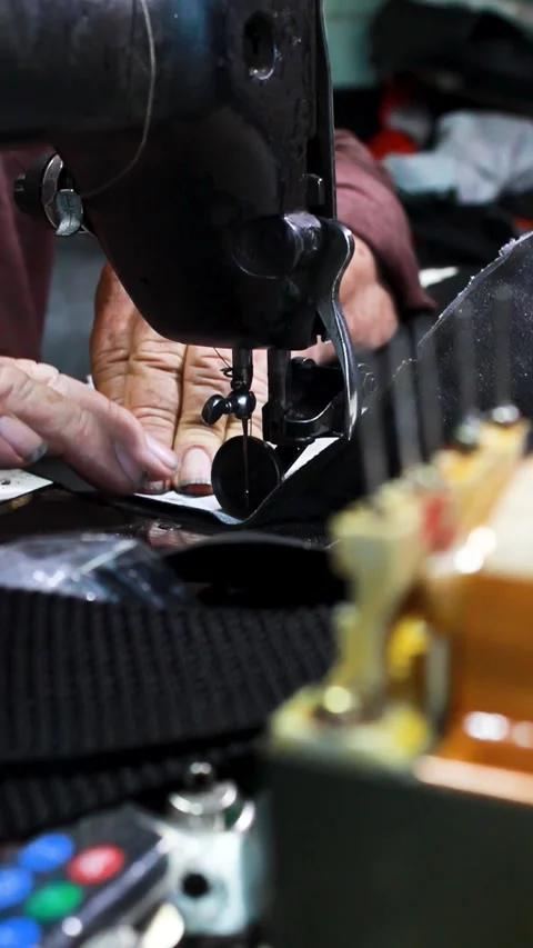 An upholsterer working on a sewing machine Stock Footage 304713860