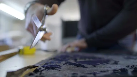 Upholstery workshop. Man with scissors cutting fabric Stock Footage 122061311