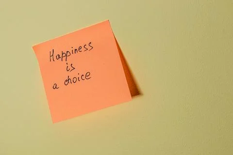 Uplifting message on a sticky note affixed to a wall indoors Stock Photos