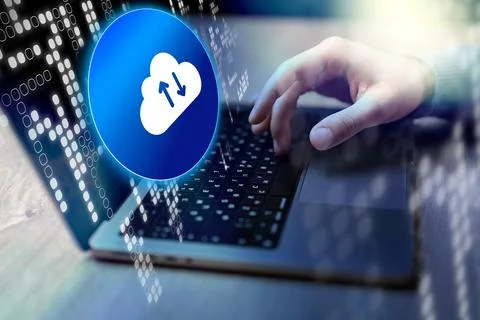 Uploading data to cloud storage using a laptop during the day at a desk Stock Photos