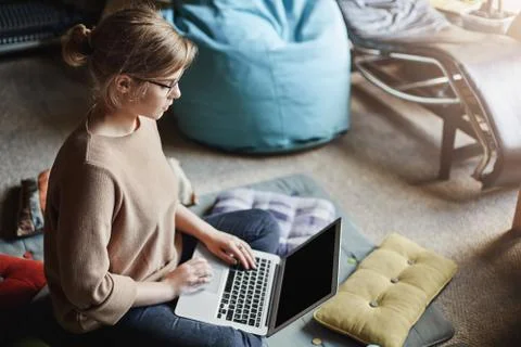 Upper-angle shot of determined attractive female in cozy outfit, sitting on Stock Photos