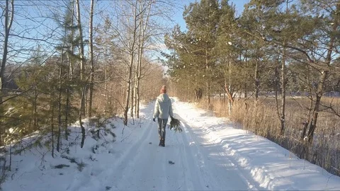 Upper backside girl with pine branch walks along wood track Stock Footage 102837466