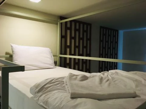 Upper bunk bed in bedroom hostel Stock Photos