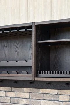 Upper cabinet of toned black solid ash with dish dryer and bottle and winegla Stock Photos