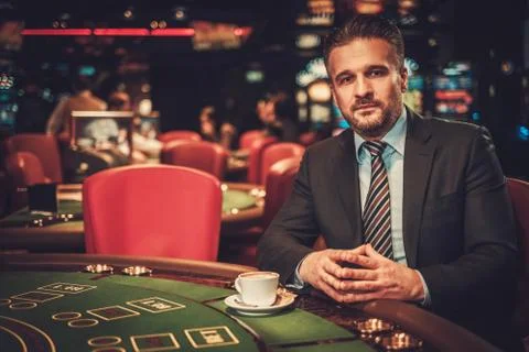 Upper class man behind gambling table in a casino Stock Photos