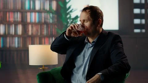 Upper class member drinking too much scotch whiskey with his friend Stock Photos