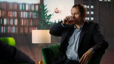 Upper class member drinking too much scotch whiskey with his friend Stock Photos
