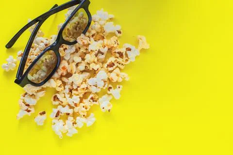 In the upper corner there are glasses on popcorn on a yellow background. top Stock Photos