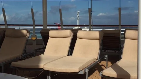 Upper deck cruise ship poolside 2 lounge chairs Stock Footage 71130894