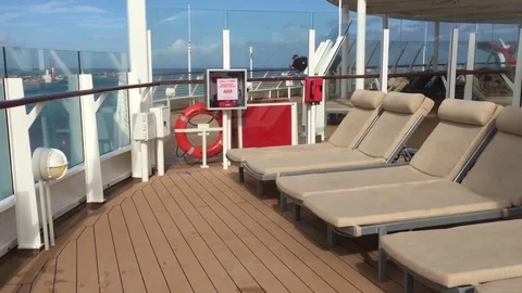 Upper deck cruise ship poolside lounge chairs far away Stock Footage 71131035