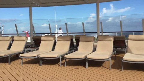Upper deck cruise ship poolside lounge chairs far away Stock Footage 71131251