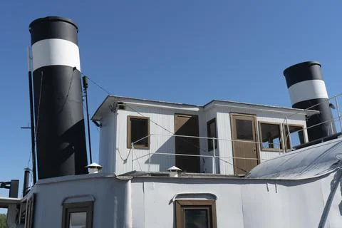 The upper deckhouse of an old ship with two exhaust pipes. Stock Photos