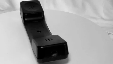 The upper facing receiver and phone moving in circular motion on white Stock Footage 111887653