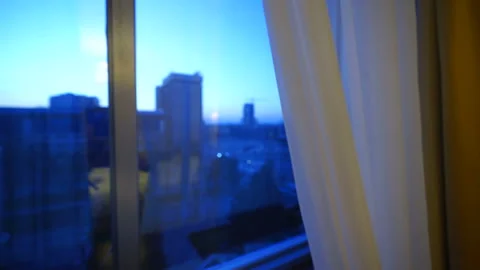 Upper floor apartment or hotel room window with early morning city view. Stock Footage 105671459