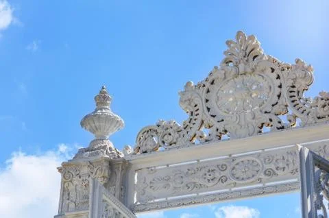Upper fragment of the white carved marble gate of the Dolmabahche Palace agai Stock Photos