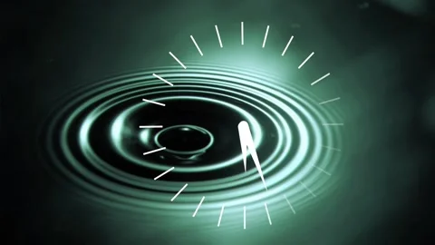 Upper-left droplets falling, striking plane, creating ripples while clock Stock Footage 333837989