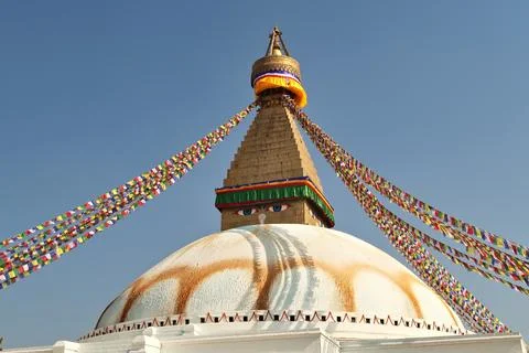 The upper part of the Boudhanath Stupa, many colorful prayer flags are atta.. Stock Photos