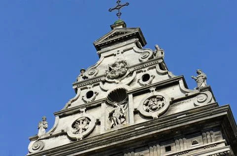 The upper part of the facade of the old Catholic church. sculptural elements Stock Photos