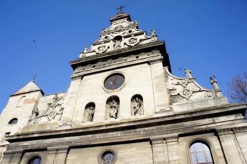 The upper part of the facade of the old Catholic church. medieval architecture Stock Photos