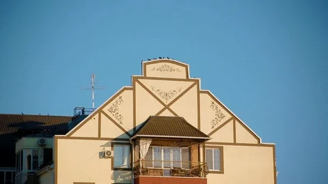 Upper part of interesting red-yellow house-hotel of European style Video stock 118064563