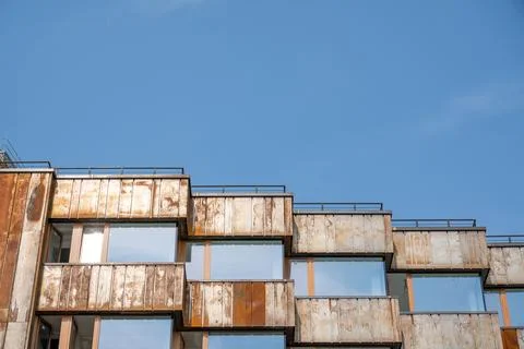 Upper part of modern building with rusted metal panels and blue sky Urbino .. Stock Photos