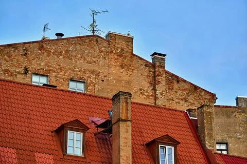Upper part of the old building with a red roof Foto stock