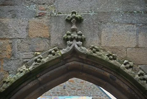 Upper part of stone archway with cross on the middle Stock Photos