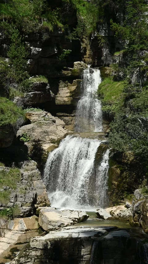 The upper part of a threefold waterfall with a pond, vertical shot Video stock 260869752