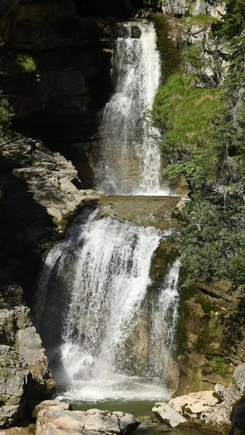 The upper part of a threefold waterfall with a pond, vertical shot Video stock 260869784
