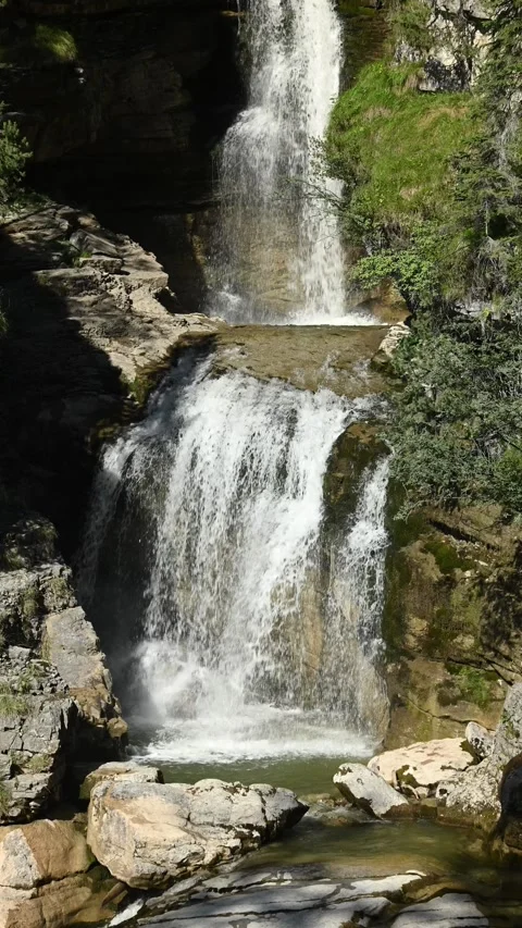 The upper part of a threefold waterfall with a pond, vertical shot Video stock 260869906