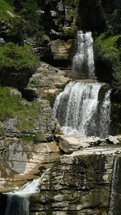 The upper part of a waterfall between rocks, in summer, vertical shot Stock Footage 260870395