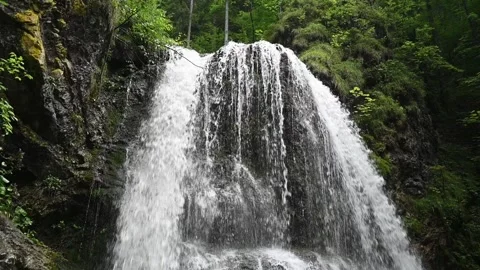 Upper part of a wild twofold waterfall in a forest in the evening in slow motion Stock-Footage 260934534